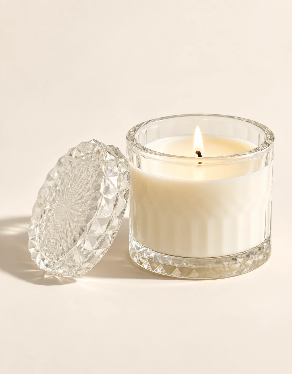Faceted Crystal candle with matching lid resting beside the jar